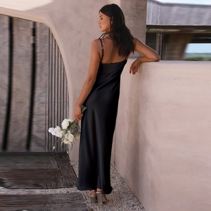 Elegant black satin backless slip dress with a slit and thin straps for women