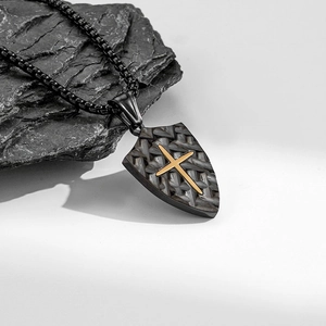 Retro shield pendant necklace with gold cross and carbon fiber texture on dark rock