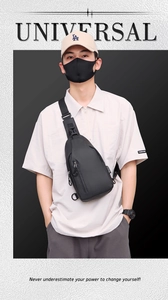 Front detail of black multifunctional chest bag with USB port and adjustable strap