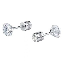 Macro shot of silver knot earrings with large round clear zircon and textured backings