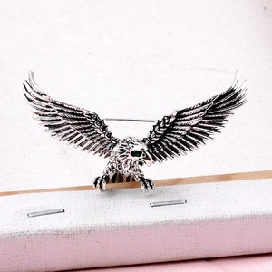 Vintage silver eagle brooch with spreading wings and green gemstone eyes for men