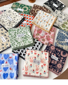 Close-up of assorted floral cotton neckerchiefs with delicate lace edges and trendy prints