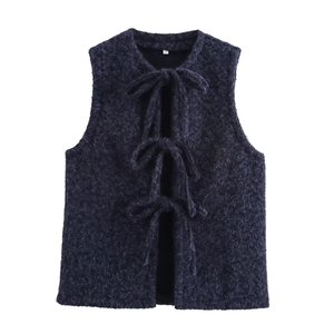 Detail of navy blue mohair vest featuring three front tie-up closures on soft fabric