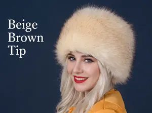 Close-up of winter faux fox fur hat in beige with brown tips and thick thermal lining