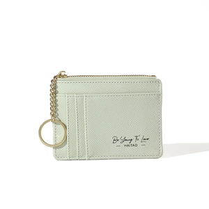 Detail view of light green PU leather card holder with multiple slots and gold zipper