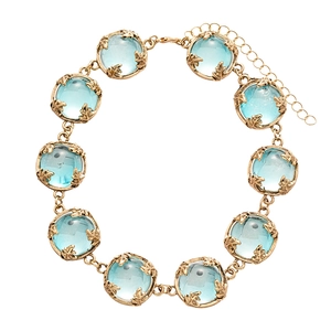 Vintage necklace with light blue resin stones in golden vine-patterned settings