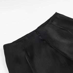 Detailed macro view of the pleated black fabric texture and side invisible zipper