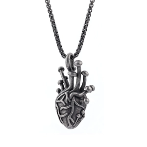 Vintage silver heart pendant necklace with unique mushroom accents for a trendy street look
