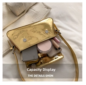 Internal capacity of gold patent leather baguette bag showing daily essentials inside