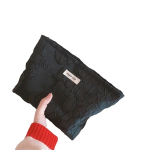 Elegant black fabric makeup bag with floral embroidery and simple wish label