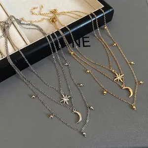 Three-layer star and moon pendant necklace set with rhinestone accents in gold and silver