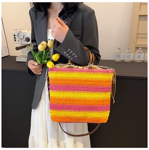 Detail of colorful striped woven beach bag with bamboo handle and drawstring closure