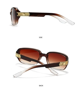 Detail of vintage square pilot sunglasses with amber frames and gold metal temple accents