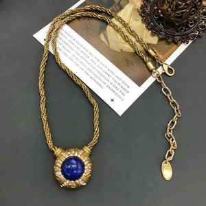 Vintage gold necklace with lapis lazuli pendant and diamonds on a rustic chain