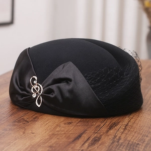 Elegant black wool beret with satin bow, rhinestone treble clef, and vintage mesh veil