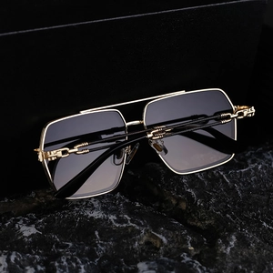 Detail of premium gold metal hinges and dark gradient lenses on vintage square sunglasses