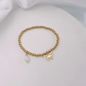 Detail of 18k gold plated beaded bracelet featuring a butterfly charm and white pearl
