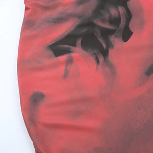 Close-up of red and black gradient smoke print on smooth fitted dress fabric
