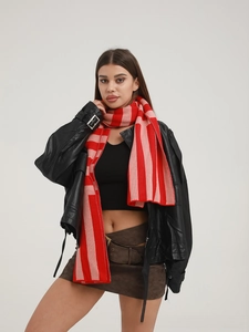 Close-up of vibrant red and pink striped knit scarf texture and thick winter material