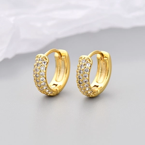 Close-up of 18K gold-plated huggie earrings with micro-pave white zircon stones