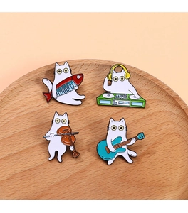 Nahaufnahme von vier Cartoon-Katzen-Emaille-Anstecknadeln mit Musikinstrumenten