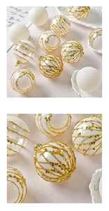 Detailed close-up of 6cm white and gold Christmas ball ornaments with star patterns and glitter