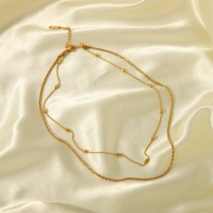 Double-layered gold stainless steel twisted chain necklace with cylindrical bead accents