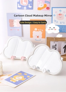 Detail of cute cloud-shaped vanity mirror with stable round support stand for desk