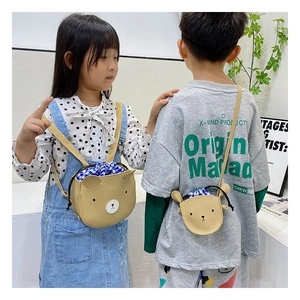 Detail of cute bear crossbody bag with textured PU leather and blue checkered drawstring