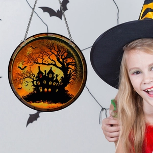Detail of Halloween pumpkin bat acrylic hanging ornament with spooky castle design