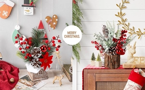 Detail of Christmas desktop ornaments featuring pine branches, red berries and wooden pots