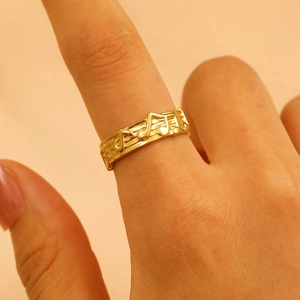 Close-up of golden sheet music and note ring on finger with soft lighting detail