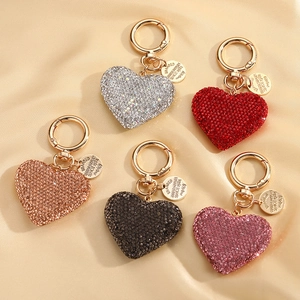 Sparkling heart-shaped rhinestone keychains in five colors on premium champagne silk fabric