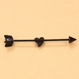 Detailed view of a black arrow industrial barbell featuring a heart decoration