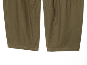 Detail of dark olive cargo pants hem with durable twill cotton fabric and precise stitching
