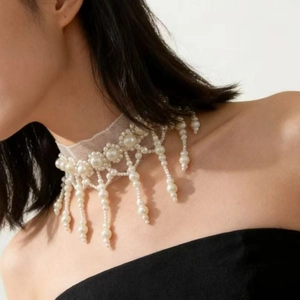 Vintage French lace choker with cascading pearl tassels worn by a model in studio light
