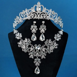 Luxurious bridal jewelry set with sparkling rhinestones on a necklace, earrings, and crown