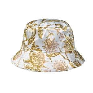 Detail of white satin bucket hat featuring vintage golden botanical floral print patterns