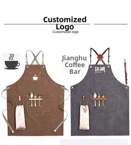 Close-up of durable canvas apron pockets with towel loop and customized coffee logo