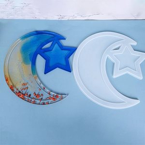 Detail view of moon and star resin mold with a blue and gold gradient DIY tray sample