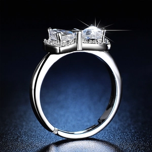 Macro side view of silver bow-knot ring with a sparkling round-cut moissanite stone