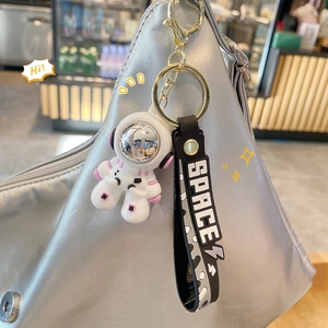 Cool cartoon astronaut keychain with black SPACE wrist strap on a silver bag