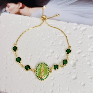 Close-up of 18K gold plated Virgin Mary bolo bracelet with sparkling green zircon stones