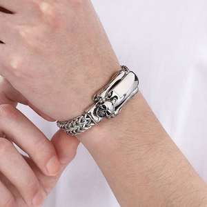 Men's stainless steel bracelet with skull clasp and polished metal plate on wrist