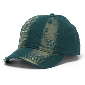 Detail of distressed dark green cotton baseball cap with vintage frayed edges and torn fabric