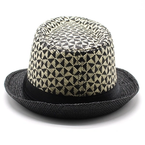 Detail of the black and white geometric weave texture on a men's summer straw fedora hat
