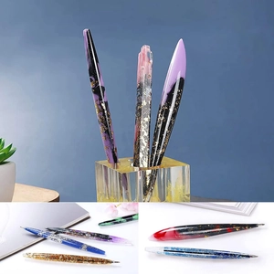 Detailed close-up of colorful resin pens with gold foil inlay and streamlined design