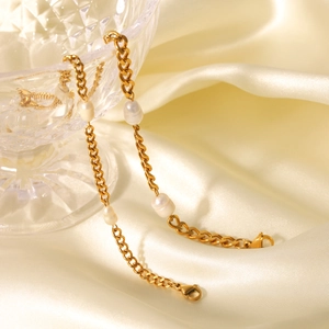 French style 18K gold plated Cuban chain bracelet with freshwater pearls on white satin