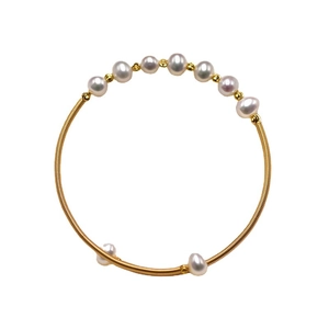Handmade gold spiral wire open bracelet with elegant white pearls in ethnic style