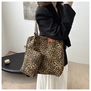Close-up of leopard print tote bag and matching pouch set with canvas texture and side pocket
